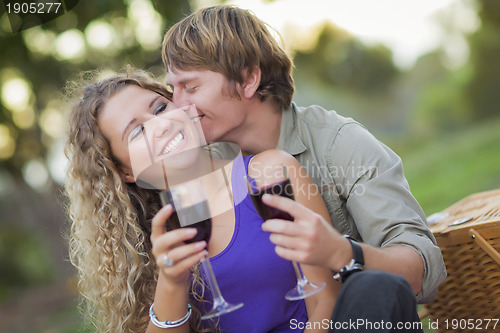 Image of An Attractive Couple Enjoying A Glass Of Wine in the Park