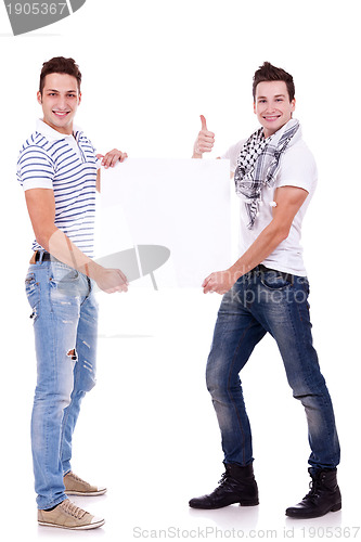 Image of two young men holding a blank board 