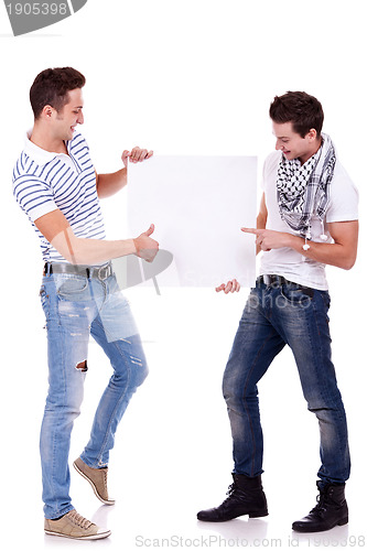 Image of two young men holding a blank board 