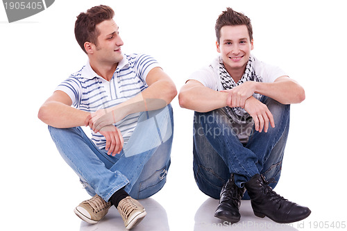 Image of two casual men sitting on a white background