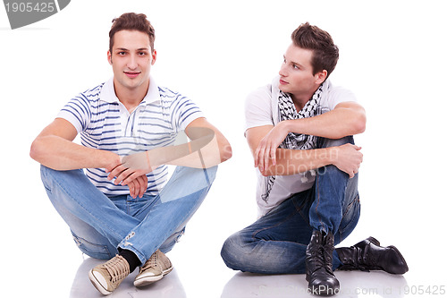 Image of two casual men sitting on a white background