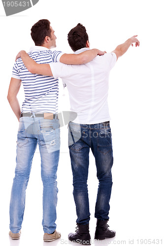 Image of  two young men pointing at somethin