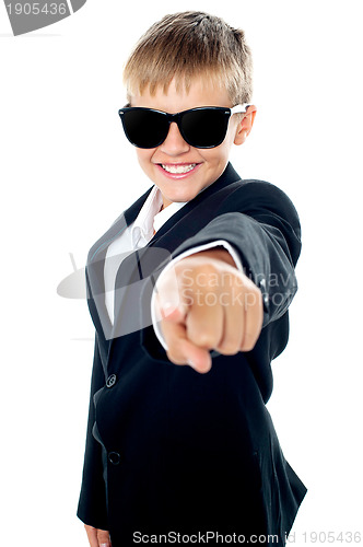 Image of Cheerful young kid pointing towards the camera