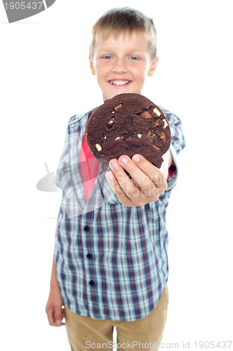 Image of Sweet little boy offering you a chocolate cookie