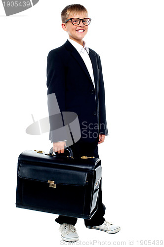 Image of Full length portrait of cute boy carrying a briefcase