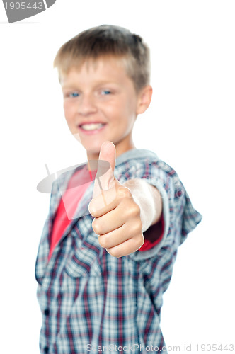 Image of Adorable young caucasian boy showing thumbs up sign