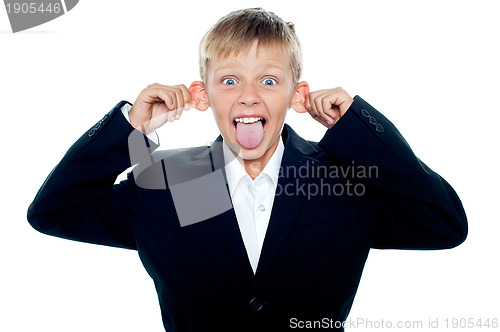 Image of Notorious little boy making faces and teasing