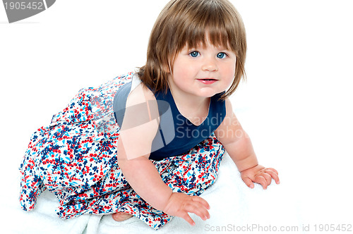 Image of Adorable 10 months old baby girl crawling