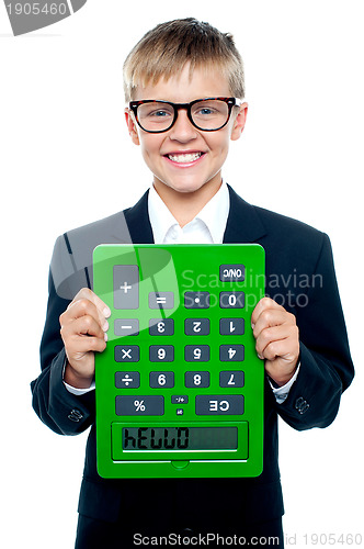 Image of School boy holding calculator upside down