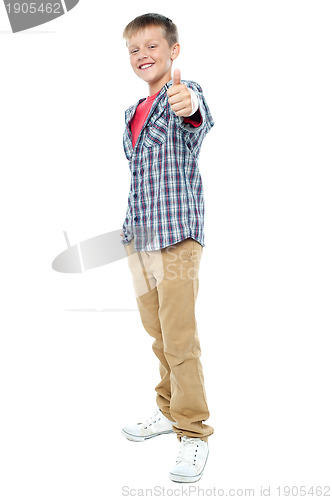 Image of Smartly dressed young kid showing thumbs up gesture