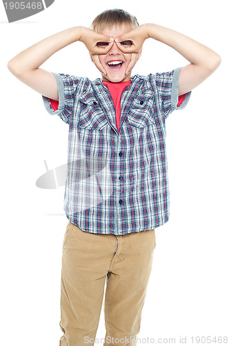 Image of Boy making mock spectacles with his hands