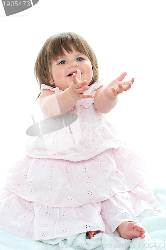 Image of Adorable blonde baby asking for her toys