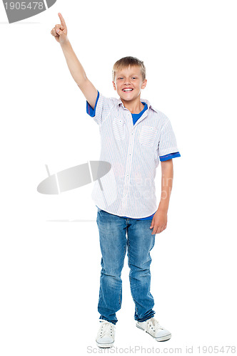 Image of Charming casual boy pointing upwards