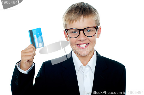 Image of Young kid in business suit flaunting a debit card