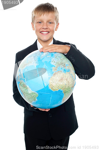 Image of Cheerful boy in suit holding globe with both hands