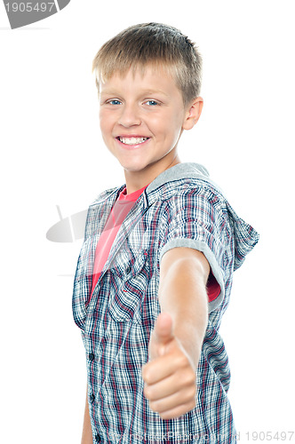 Image of Handsome young boy gesturing thumbs up sign