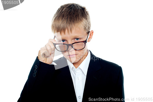 Image of Cute little business boy looking through his eyeglasses
