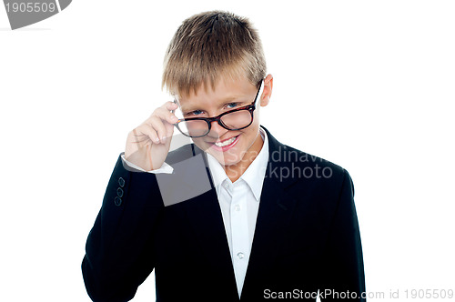 Image of Young business boy looking through his glasses