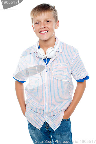 Image of Fashionable kid posing with headphones around his neck