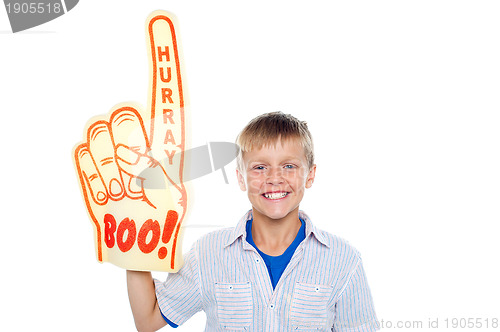 Image of Boy with a hurray boo foam hand. Young fan