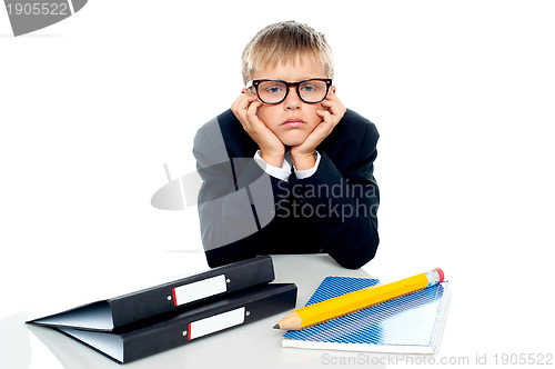 Image of Sad looking boy with hands on his cheeks