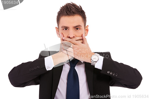 Image of business man making the speak no evil gesture