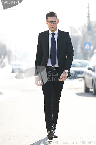 Image of business man walking towards the camera