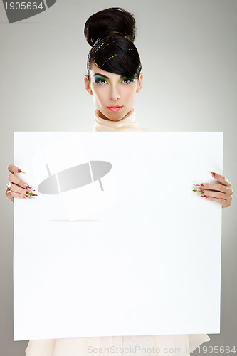 Image of fashion woman presenting blank board