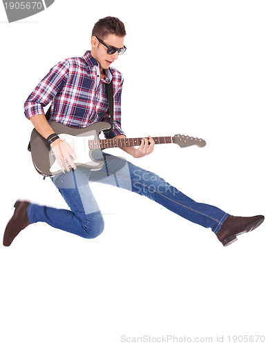 Image of guitarist playing an electric guitar while jumping