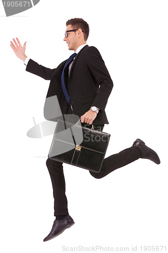 Image of business man with glasses and suitcase jumping