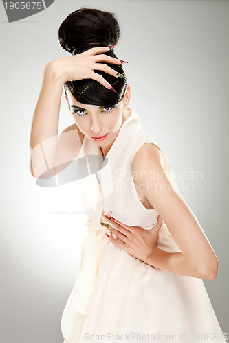 Image of brunette lady in dress posing