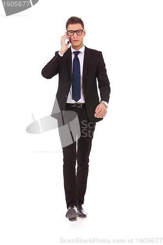 Image of business man with glasses talking on mobile phone