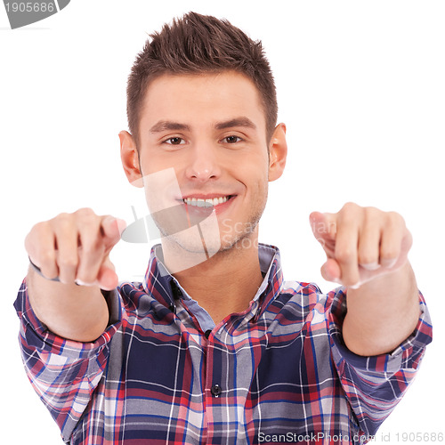 Image of young casual man pointing