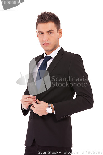 Image of business man buttoning his coat 