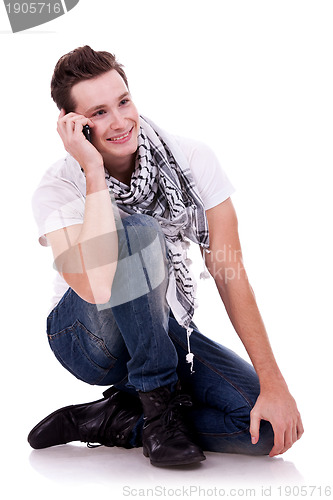 Image of man talking on the phone while sitting