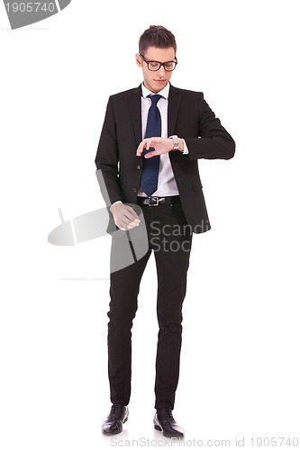 Image of business man wearing glasses looking at watch