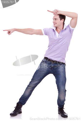 Image of Casual young man pointing to blank space