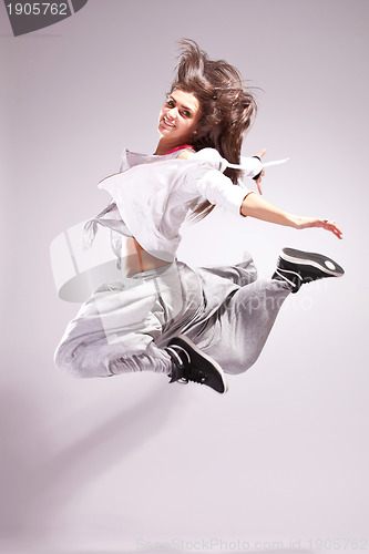 Image of  woman dancer smiling and jumping