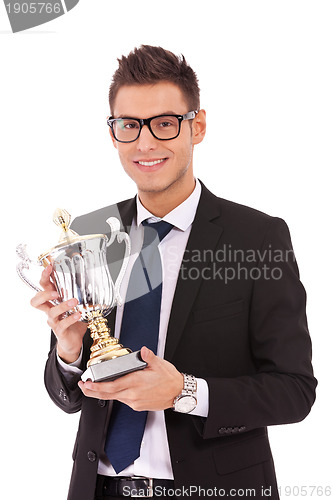 Image of business man holding a trophy