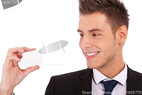 Image of  business man looking at a card 