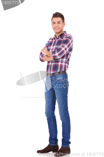 Image of trendy man standing with arms crossed 