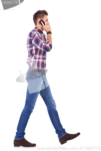 Image of casual man talking on the phone and walking