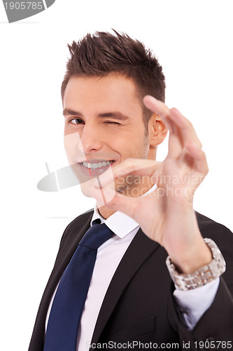 Image of Business man winking with ok sign