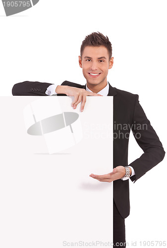 Image of young business man showing  board