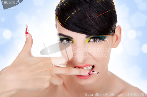 Image of sexy aggressive woman biting her middle finger