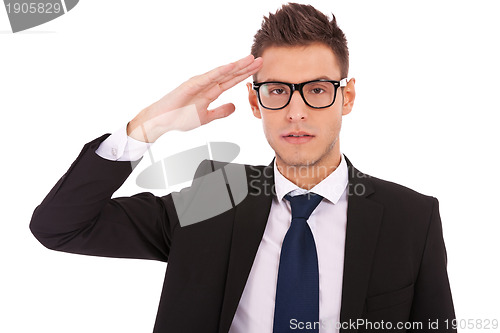 Image of Business man wearing glasses gives salute