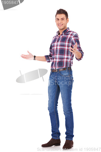 Image of casual man gesturing welcome
