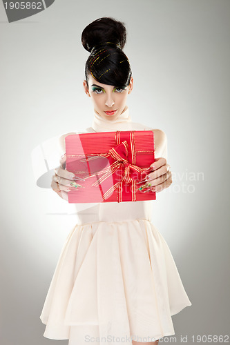 Image of Young  woman holding gift