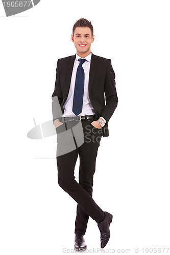 Image of business man standing with hands in pocket 