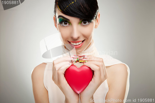 Image of young woman  holding a heart